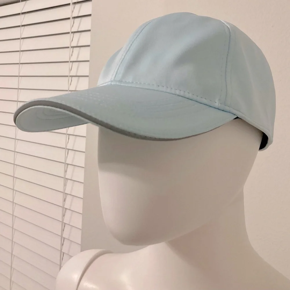 light blue baseball cap with reflective stripe on the peak self-adjusting .